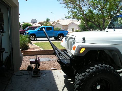 1986 Toyota Hilux - White Jeep Wrangler parked in driveway next to a blue pickup truck and a red truck.