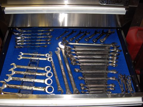 2007 Ford Mustang - A variety of wrenches are neatly organized in a tool drawer on a blue mat.