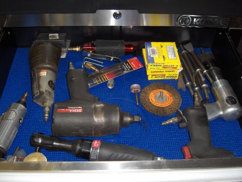 2007 Ford Mustang - A collection of pneumatic tools and accessories are neatly organized in a toolbox drawer.