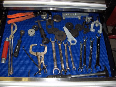 2007 Ford Mustang - A collection of various hand tools, including wrenches and pliers, are organized in a toolbox drawer.