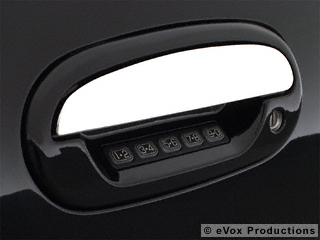 2007 Ford Mustang - Close-up of a black car door handle with a digital keypad and keyhole.