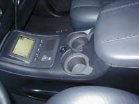 2007 Ford Mustang - Center console of a 2007 Ford Mustang, showing the navigation unit and cup holders.