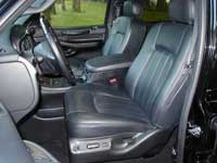 2007 Ford Mustang - View of the driver and passenger seats inside a black vehicle, showing the leather upholstery and dashboard details.