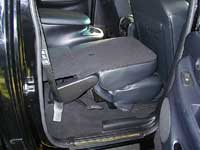 2007 Ford Mustang - View of the rear passenger area of a car, showing the folded seats and door panel.