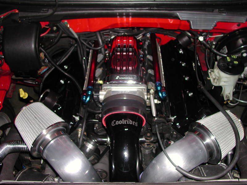 Engine bay with twin air intakes, polished intake manifold, and "Coolrides" branding on a black intake tube