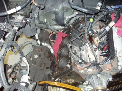 2007 Ford Mustang - Close-up view of a vehicle's engine bay, showing the engine block, numerous wires, and hoses.