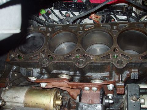 2007 Ford Mustang - Close-up view of an engine block's cylinders and associated mechanical components.