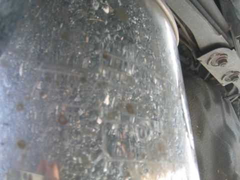 1993 Ford Probe - Underside view of a vehicle's exhaust pipe, showing dirt and some faint markings.