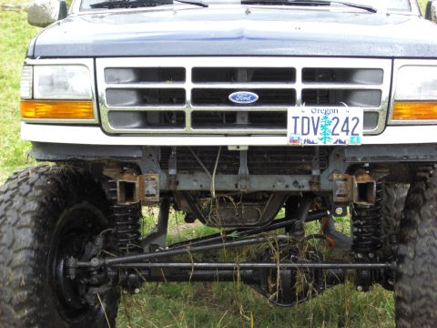 1993 Ford Bronco - Front view of a modified 1992 Ford Bronco with oversized tires and suspension components visible.