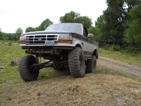 1993 Ford Bronco - This heavily modified Ford pickup truck features an extreme suspension lift and oversized tires for off-road use.