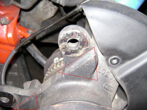 1991 Ford Taurus - Detail of a vehicle's suspension part, showing stamped markings and red highlighting.