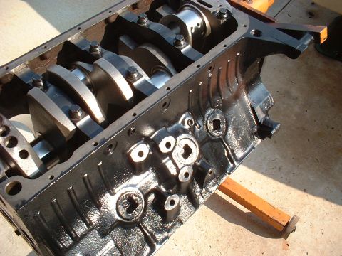 1957 Ford Custom Sedan - Close-up view of an engine block's internal components, including the crankshaft and connecting rods.