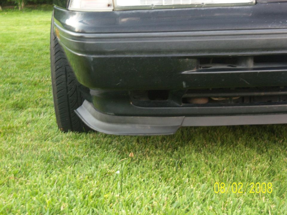 1989 Mazda MX-6 front bumper corner and tire on grass