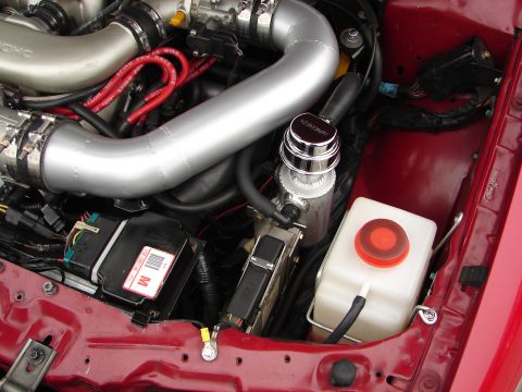1992 Ford Taurus - Close-up view of a car's engine bay, showing various components and wiring.