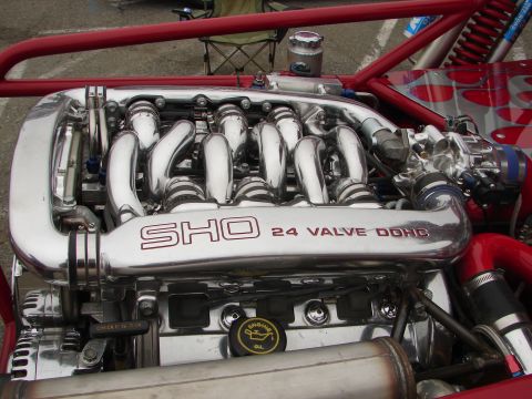 1992 Ford Taurus - The engine features a SHO 24 Valve DOHC badge and chrome components, set against a red roll cage.