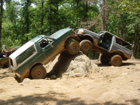 1995 Ford Bronco - Two Ford Broncos navigate a challenging rocky terrain during an off-road excursion.