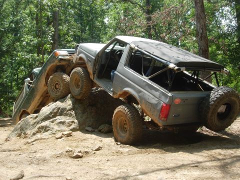 1995 Ford Bronco - Two off-road vehicles navigate a challenging rocky terrain during an outing.