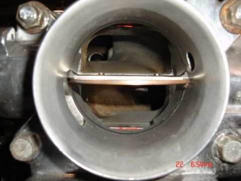 1993 Ford Probe - A close-up shot shows the interior of a throttle body, revealing the butterfly valve and its housing.
