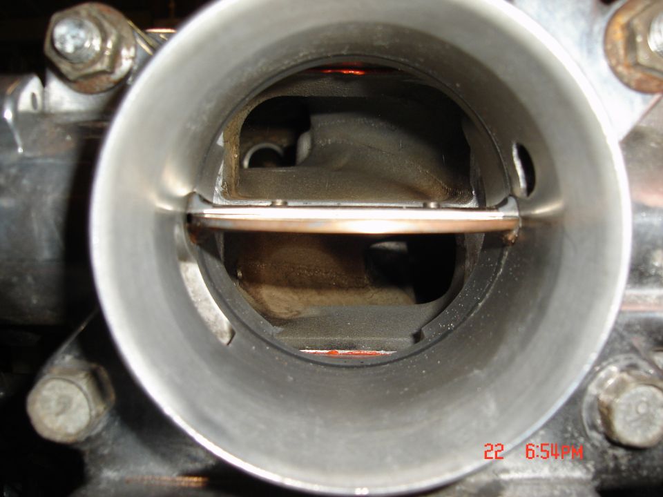 Inside view of a throttle body with the butterfly valve visible. There's a timestamp in the corner reading 22 6:51