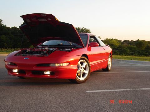 1993 Ford Probe - A red 1993 Ford Probe is shown from a three-quarter front view with its hood open, parked on an asphalt surface.