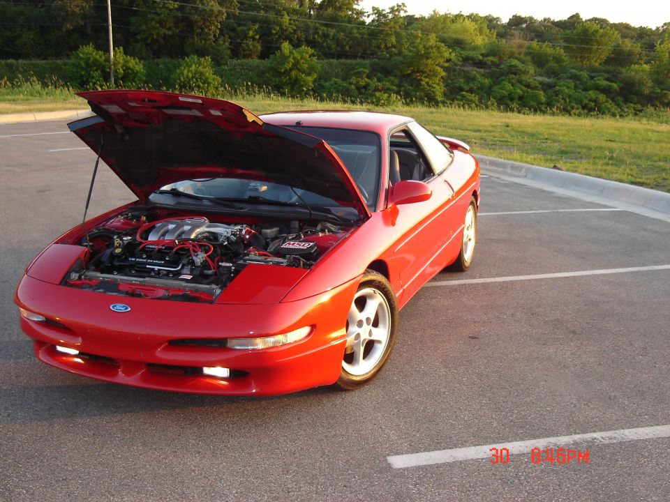 Red 1993 Ford Probe with hood open, front view. Engine visible