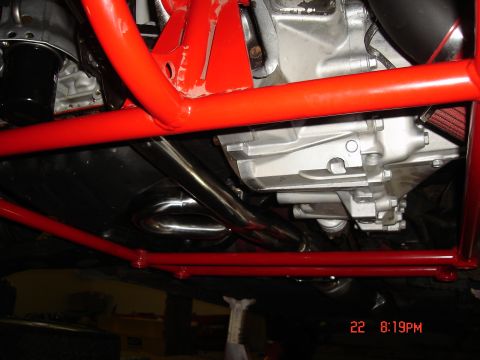 1993 Ford Probe - The underside of a vehicle is visible, showing engine components and a red roll cage structure.