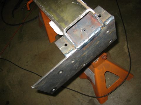1995 Ford Bronco - A custom metal bracket, likely for a vehicle modification, is shown supported by orange jack stands.