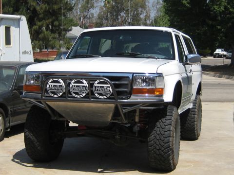 1996 Ford Bronco - This modified 1996 Ford Bronco features a custom front bumper with three Hella lights and off-road tires.