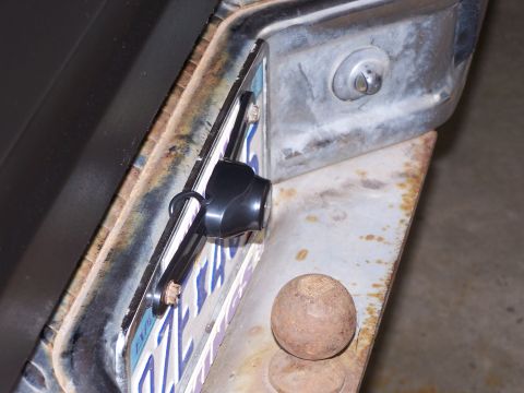 1986 Ford Bronco - A close-up view shows a backup camera installed on the rear of a vehicle, obscuring part of the license plate.