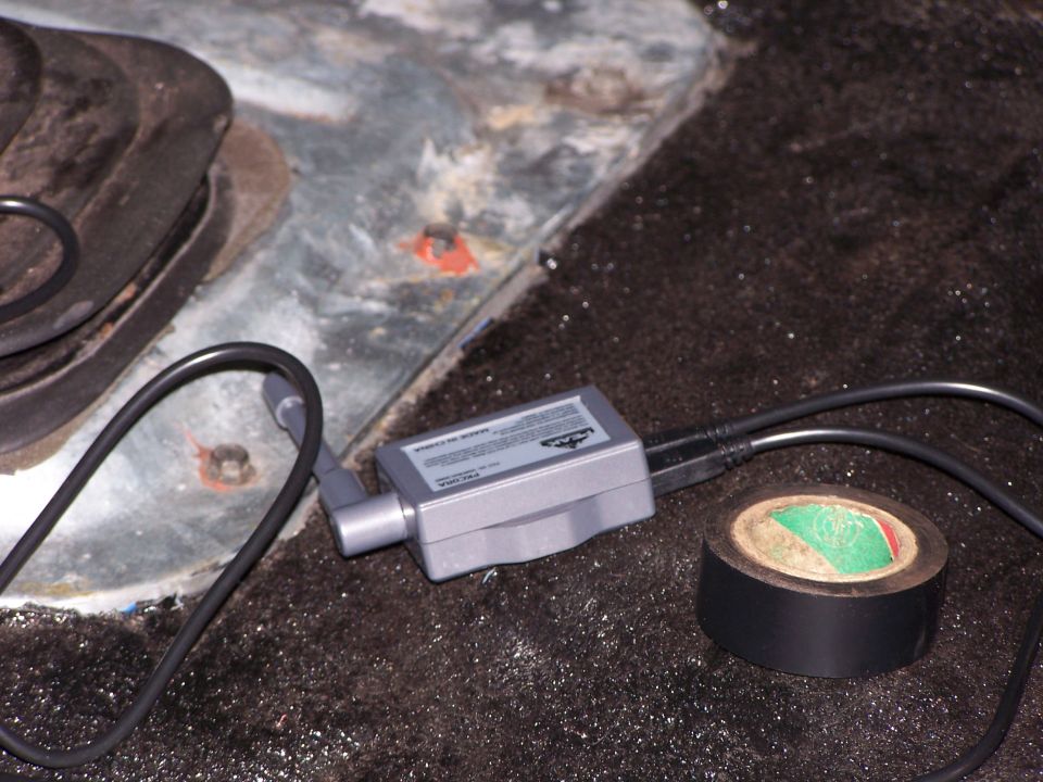 Backup camera module with tape on a dark, textured surface