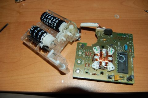 1985 Mercury Grand Marquis - Disassembled odometer and electronic control board, likely from a car's dashboard.