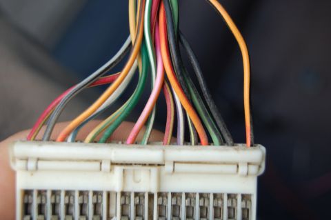1985 Mercury Grand Marquis - A close-up shows a white wiring harness connector with numerous colorful wires leading into it.