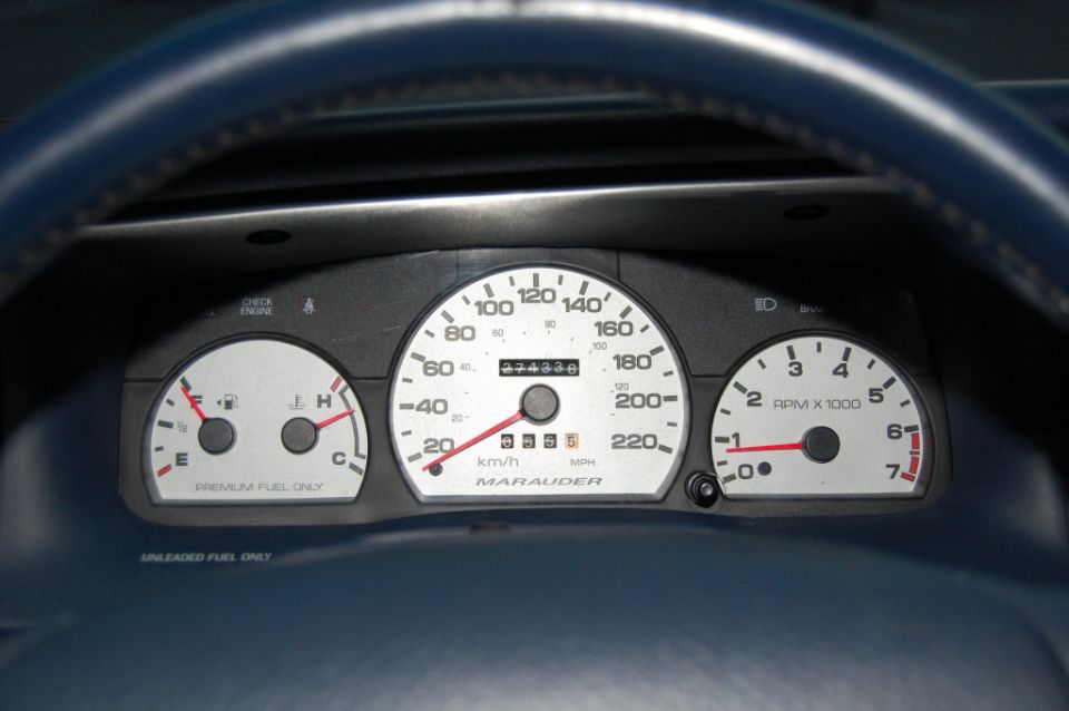 White-faced Marauder gauge cluster in a blue dash reading 274338 miles