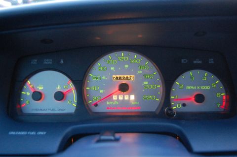1985 Mercury Grand Marquis - The illuminated dashboard gauges show the vehicle's speed, RPM, fuel level, and odometer reading.