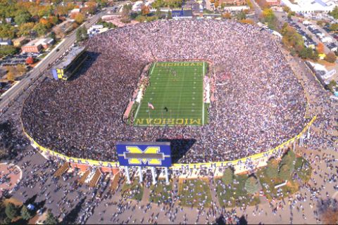 1996 Ford Bronco - A massive crowd fills the stands of Michigan Stadium during a football game, with the field visible in the center.