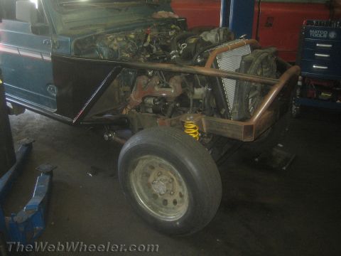1987 Suzuki Samurai - This 1987 Suzuki Samurai is undergoing modifications with a custom roll cage and exposed engine bay.