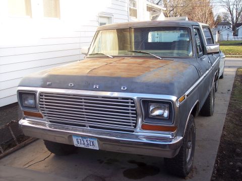 1979 Ford Bronco - This Ford truck shows significant wear on its hood and grille, with a license plate visible.