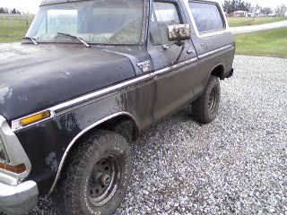1979 Ford Bronco - A black 1978 Ford Bronco is shown from the front three-quarter view on a gravel surface.