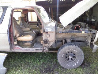 1979 Ford Bronco - This 1978 Ford Bronco is missing its doors and has its hood open, revealing the engine compartment.