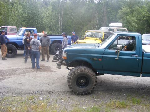 1981 Jeep CJ7 - A teal Ford F-350 pickup truck is parked with several other vehicles and people.