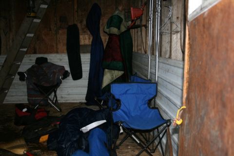 1990 Chevrolet Suburban - A cluttered storage space contains camping equipment, including chairs, sleeping bags, and a ladder, suggesting preparation for outdoor act…
