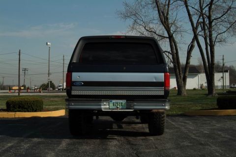 1992 Ford Bronco - Rear view of a 1992 Ford Bronco, showing its two-tone paint and chrome bumper.
