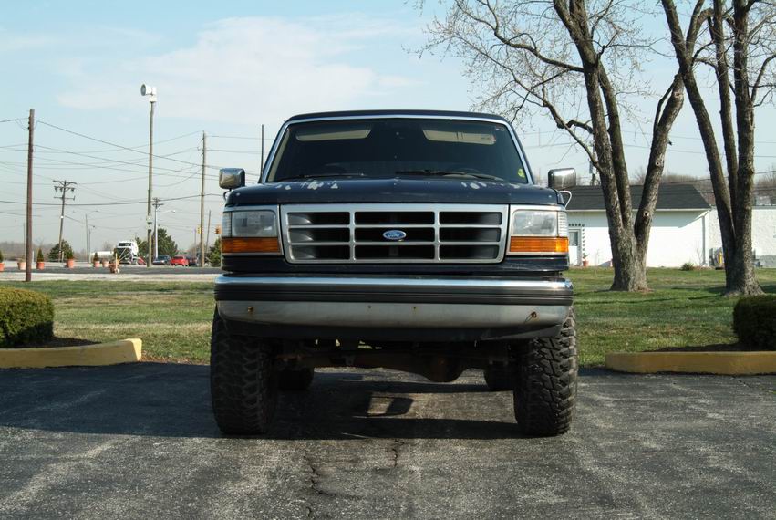 Front view of a dark blue 1992 Ford Bronco with a chrome grille