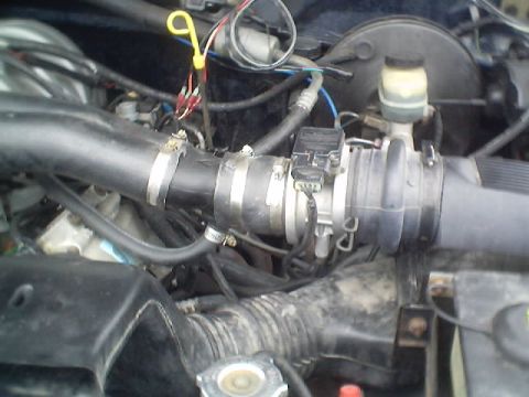 1992 Ford Bronco - Close-up view of the engine bay, focusing on the air intake system and associated sensors.