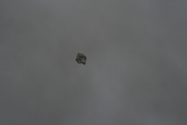 Crumpled paper debris against a gray background.