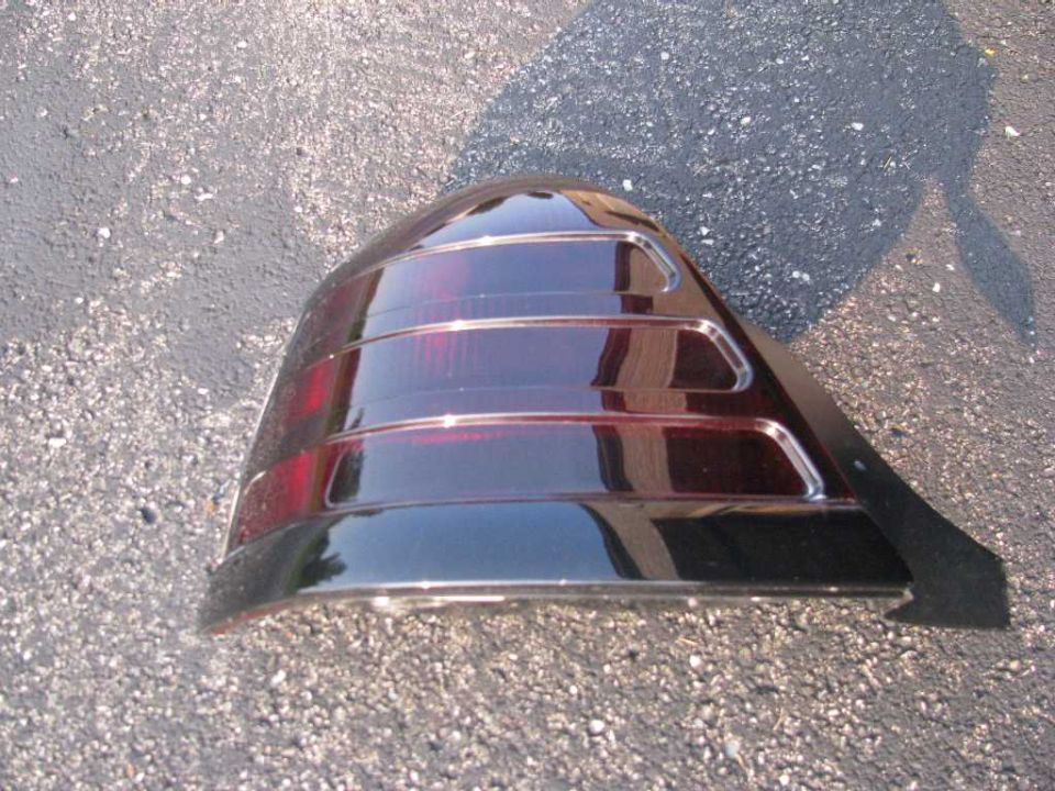 Dark red tinted tail light assembly with ribbed sections and black trim