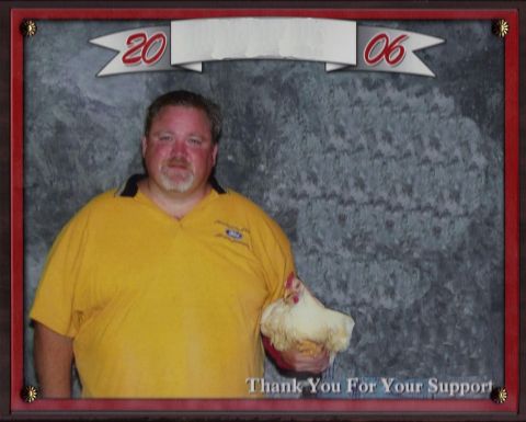 1992 Ford Bronco - A man in a yellow shirt holds a white chicken in front of a gray textured background. A banner above reads "20 06" and text at the bottom s…