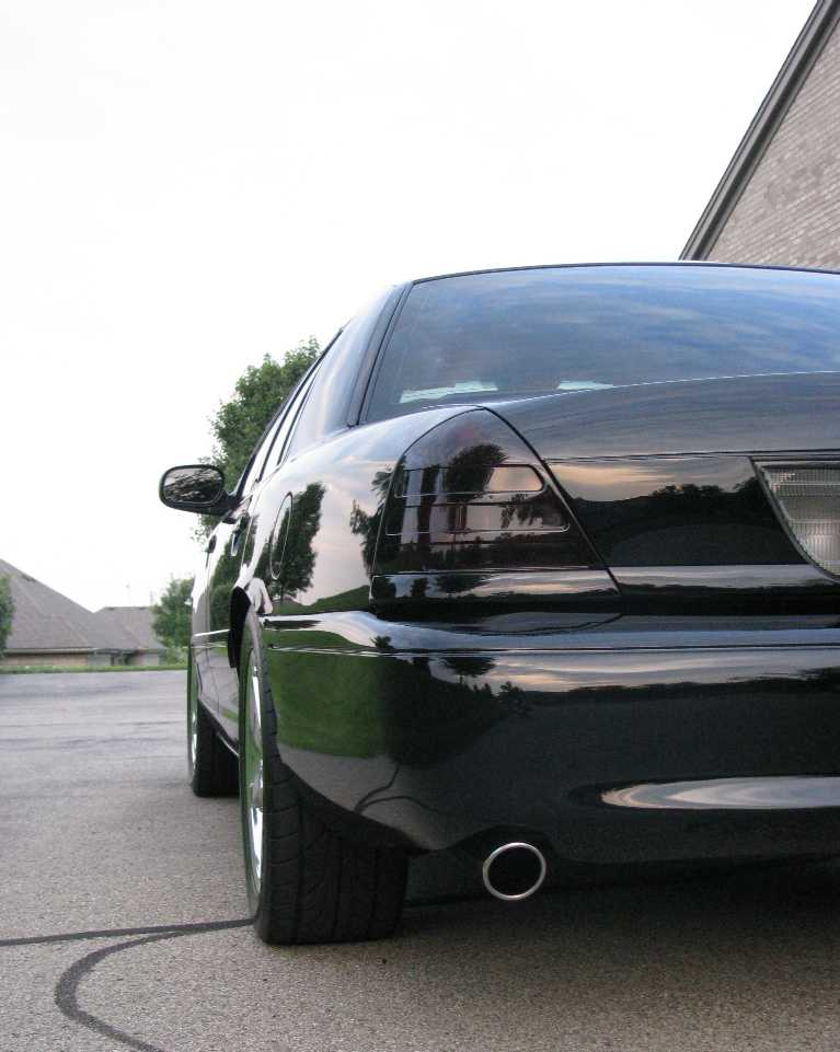 Rear view of a black Mercury Marauder with tinted taillights.