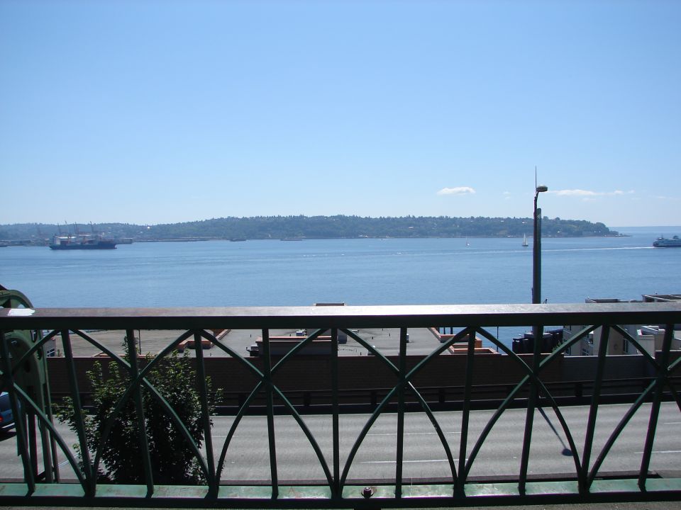 View of a body of water with a railing in the foreground.