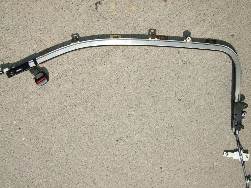 car door frame with window track and seatbelt buckle